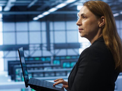 A software developer monitors digital infrastructure inside a data center
