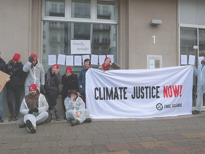 Protest action against BUND's approval of the results of the Coal Commission. During the action, the Paris Climate Agreement was hung on the windows and doors of the office building