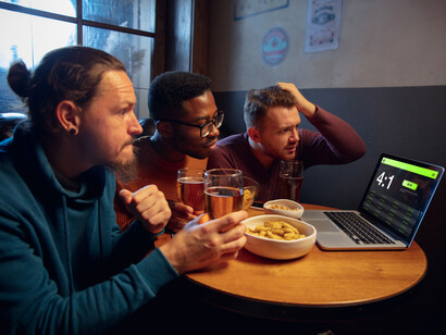 A group of men suffering over sports results