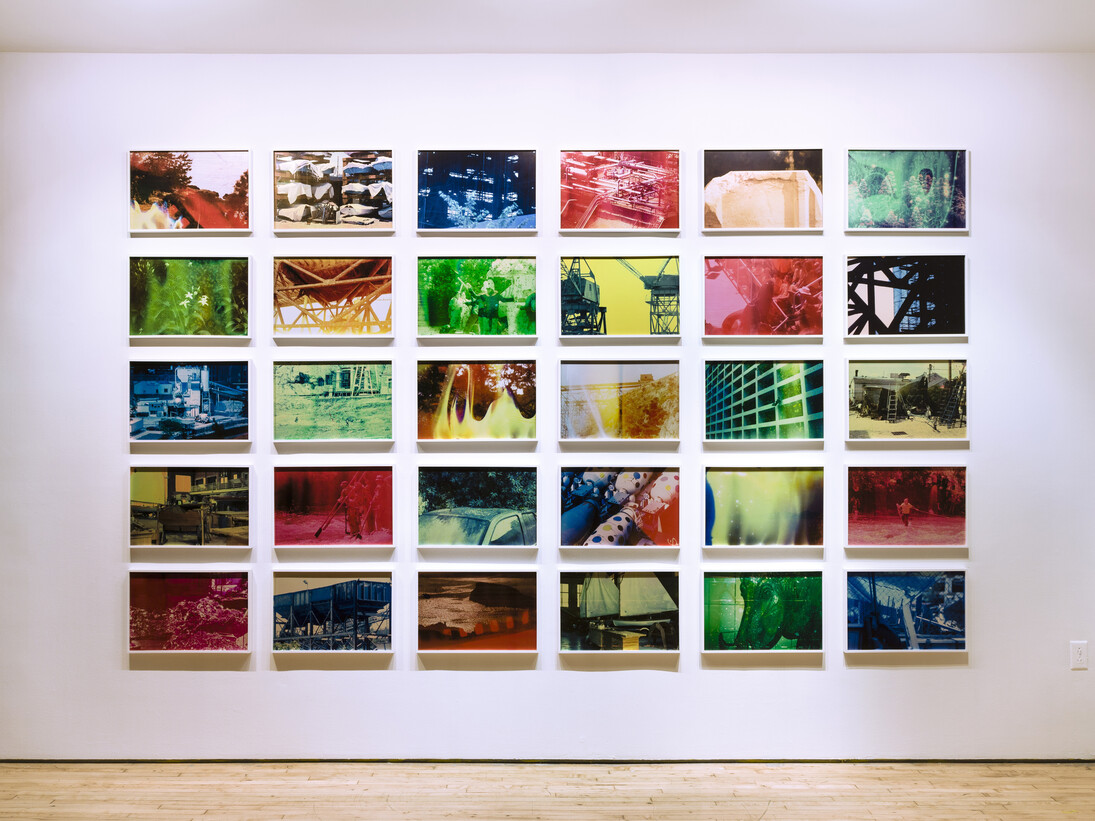 Basim Magdy, The Hollow Desire to Populate Imaginary Cities, 2014. 30 C-Prints from chemically altered slides on metallic paper 34 x 51 cm each. Installation view at Art in General. Image courtesy the artist and Art in General. Photo: Charles Benton.