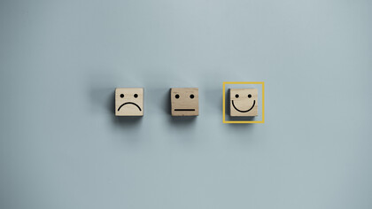 Three emoji faces: a sad face, a neutral face, and a happy face, with the happy face selected
