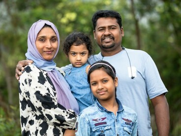 Happy migrant family posing together