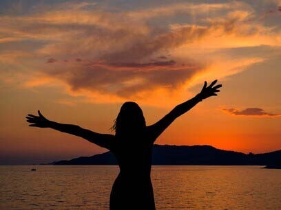Woman in a field during sunset: relish the moments while they last, and when they are gone do not dwell in the past
