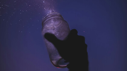 A person releasing stardust onto the night sky