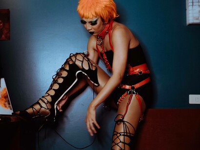 A transgender woman lacing up their boots