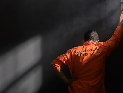 A middle-aged man serving time in prison, illustrating the incarceration process and the need for reform in the criminal justice system