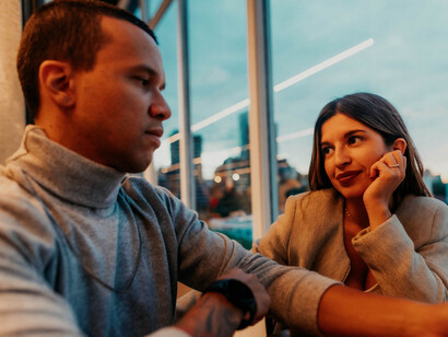 Two people engaged in thoughtful discussion at a cozy café in Buenos Aires, Argentina, enjoying a relaxed afternoon together