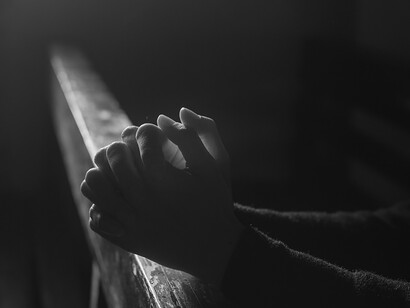 During the worship service, people raise their hands in prayerful gestures, engaging in a profound moment of worship