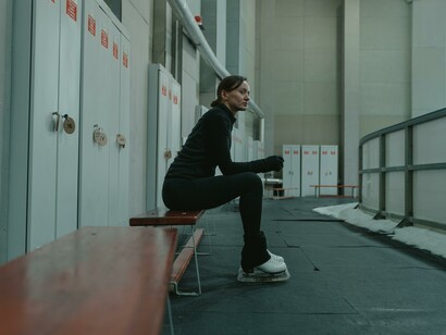 Ice skater sitting on a bench 