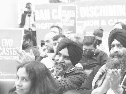 People in the crowd cheer at a comment made about prohibiting caste discrimination in Seattle, Washington at a City Council meeting Tuesday