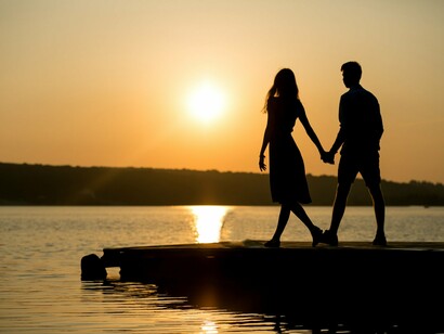 Two figures holding onto one another beside the river, symbolising the human need for closeness in tough times