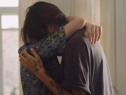 Two men hugging in grief