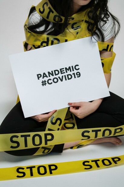 A young woman protesting to stop the Pandemic of Covid-19 