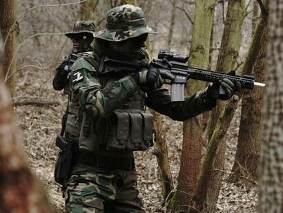 A soldier ready to fire, representing the useless of war