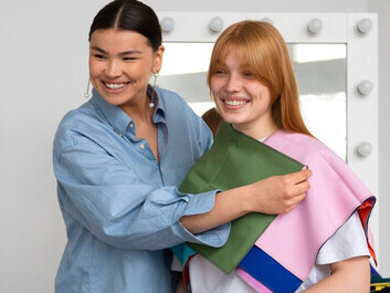 A woman displays vibrant swatches of fabric infused with nanotechnology, highlighting self-cleaning and antimicrobial features powered by silver nanoparticles, showcasing the future of sustainable fashion innovation