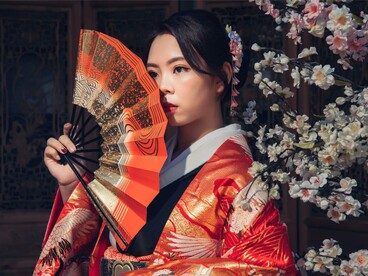A woman in an elegant kimono surrounded by traditional detailing, symbolizing the connection between cultural heritage and sustainable design