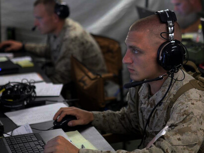U.S. Marines from Marine Air Control Group 48 monitor radar systems to identify simulated aircraft as hostile or friendly during the Marine Air Command and Control System Integrated Simulated Training Exercise (MISTEX) at the Center of Excellence in Great Lakes, Illinois, on July 21, 2013
