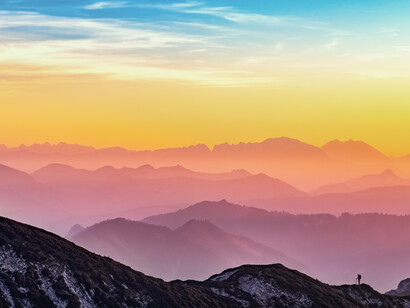 A rainbow of a sunset, inn a caravan of debris, flowering gardens and deserts 
