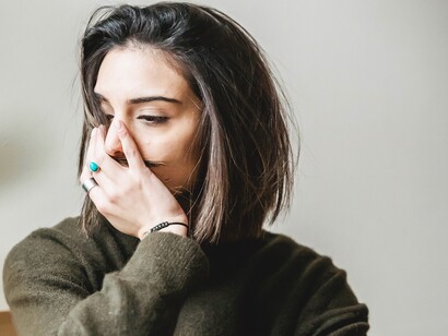 Pensive woman grabbing hair