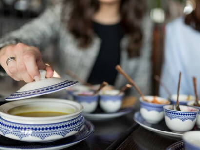 At lunchtime, two young women relish a bowl of savory lentil soup together