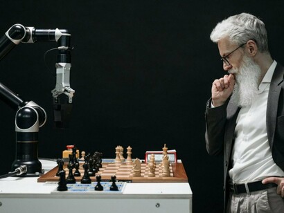 A man strategizing his next move against a robotic challenger, reflecting the competition between traditional thinking and algorithmic decision-making