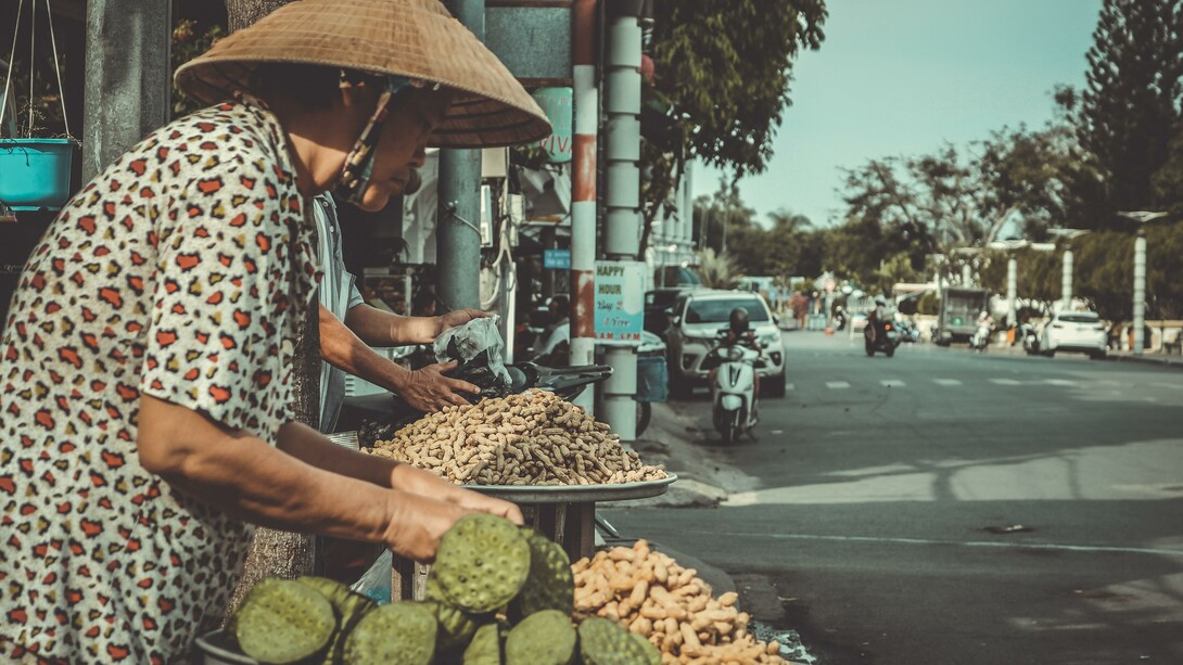 Woman selling peanuts at the side of the road