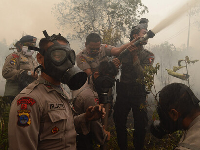 Indonesian police and firefighters extinguish a fire on Borneo island 