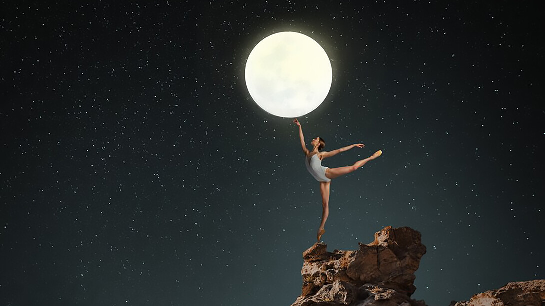 A ballerina gracefully holding the moon aloft
