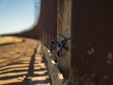 A close-up of a border fence stretching into the distance, representing the growing focus on border security in Latin America