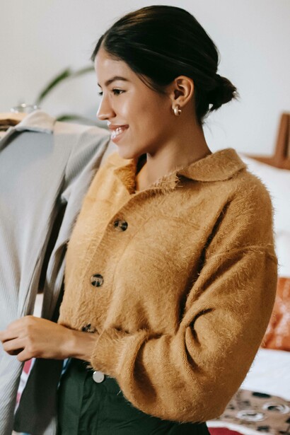 Woman smiling while showing her clothes