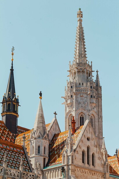 The towering spire of Matthias Church in Budapest, Hungary, representing the church's calling to stand as a beacon of faith rather than a monument to material success