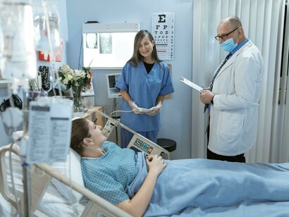 The doctor is communicating with the patient to assess their health