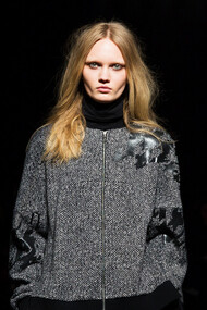 Intense and focused, this model's stare mirrors the fashion industry's urgent shift towards climate resilience and sustainable practices in 2024