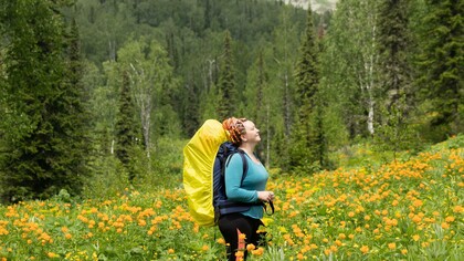 A woman hiking up a mountain as her pursuit to find a purpose inches closer