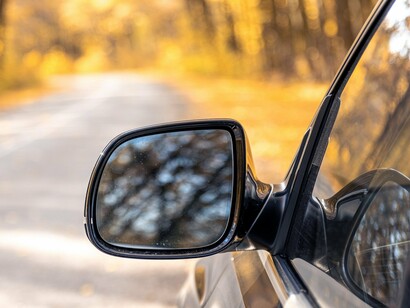 A rear view mirror showing what has already been left behind, reflecting the importance of reflection before moving forward