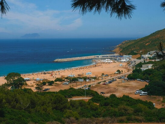 A breathtaking view of Tangier's vibrant beach in Morocco and surrounding landscape under a clear blue sky