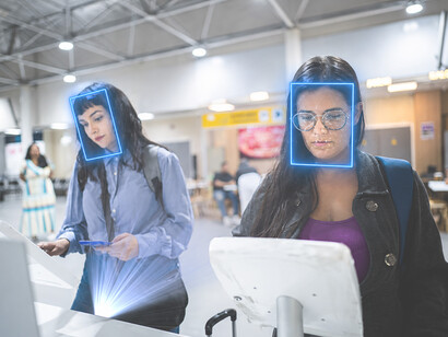 Professional travelers uses smartphone facial recognition during the airport check-in and security process