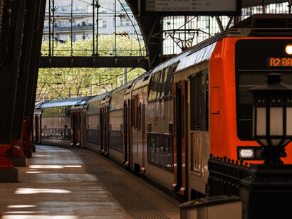Public transportation in Europe, including train stations and vehicles like those in Barcelona, plays a vital role in connecting cities and enhancing mobility, Spain