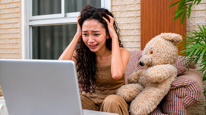 A young woman sits anxiously, realizing she has been drawn into a multilevel marketing scheme