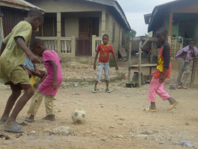 Children playing football showing the raw energy and creativity of Nigeria’s youth