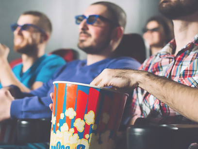A group of men watching film in cinema