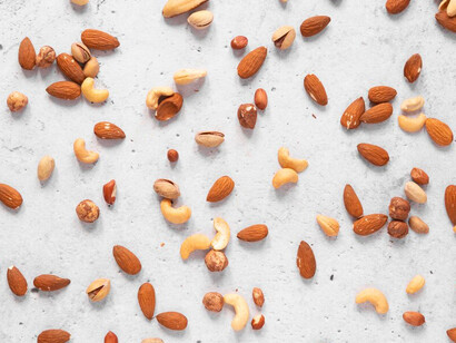 Flat lay of various nuts emphasizing their role as magnesium sources for better sleep quality and gut-brain health
