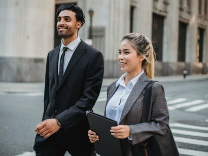 A couple in business attire engaged in conversation, reflecting the value of supporting one another through every stage of life