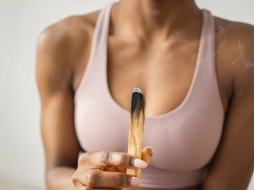 Uma mulher segura um incenso durante um momento de contemplação. Encontrar sentido também pode significar criar pausas para escutar aquilo que acontece dentro de nós