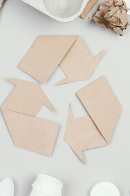 Flat lay of colorful recycling bins filled with paper, plastic, and glass waste, promoting eco-friendly practices and sustainable living