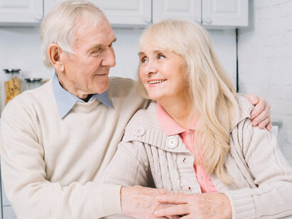 The elderly couple smiling together, reflecting joy and vitality as they embrace a long life
