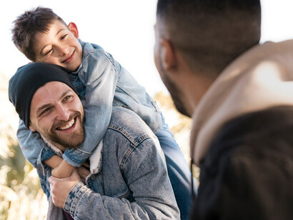 A loving same-sex couple and their children, representing the diversity of LGBTQ+ families