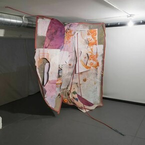 Eric Mack, Pain After Heat, 2013, rope, paper, acrylic paint, dye, ink, dried orange peel, wood, plastic, magazine image and gromets on a quilted moving blanket, 77 x 90 x 49 inches