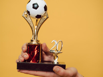 A soccer trophy held  high