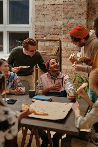 Multi racial group of friends enjoying a pizza party